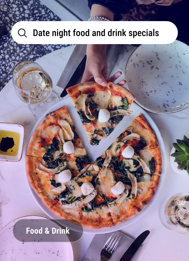 Imagery card: a pizza and wine on a marble table under the search line Date night food and drink specials, tagged Food and Drink