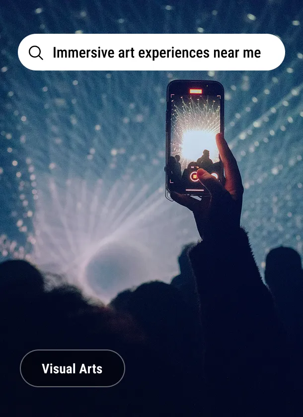 Imagery card: a phone raised in front of a projected light installation under the search line Immersive art experiences near me, tagged Visual Arts