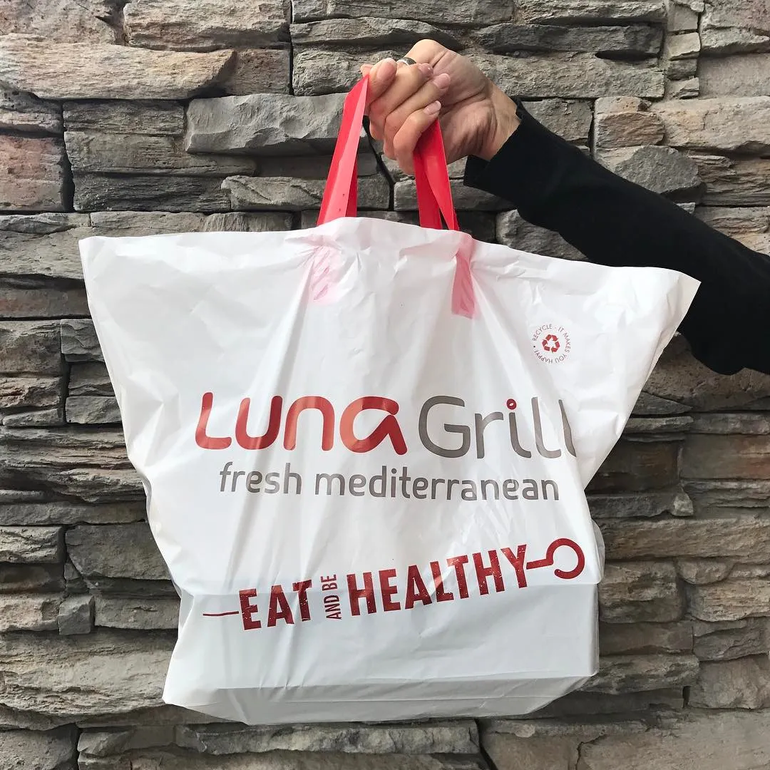 A large plastic catering bag carrying the lockup