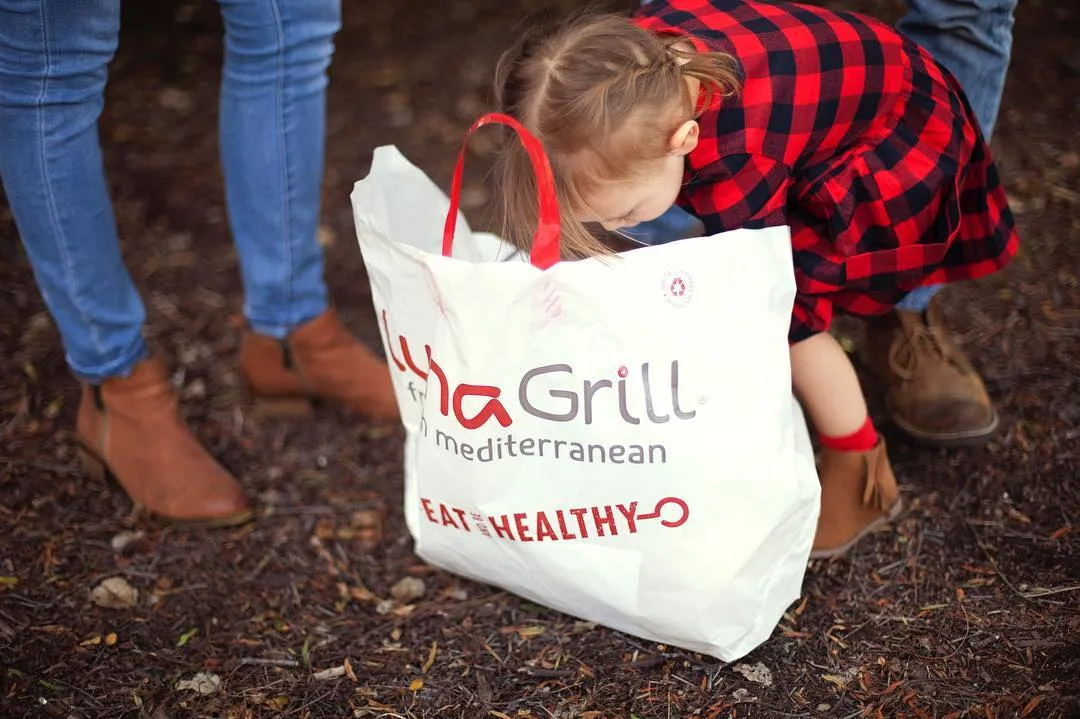 A child carrying a branded takeout bag