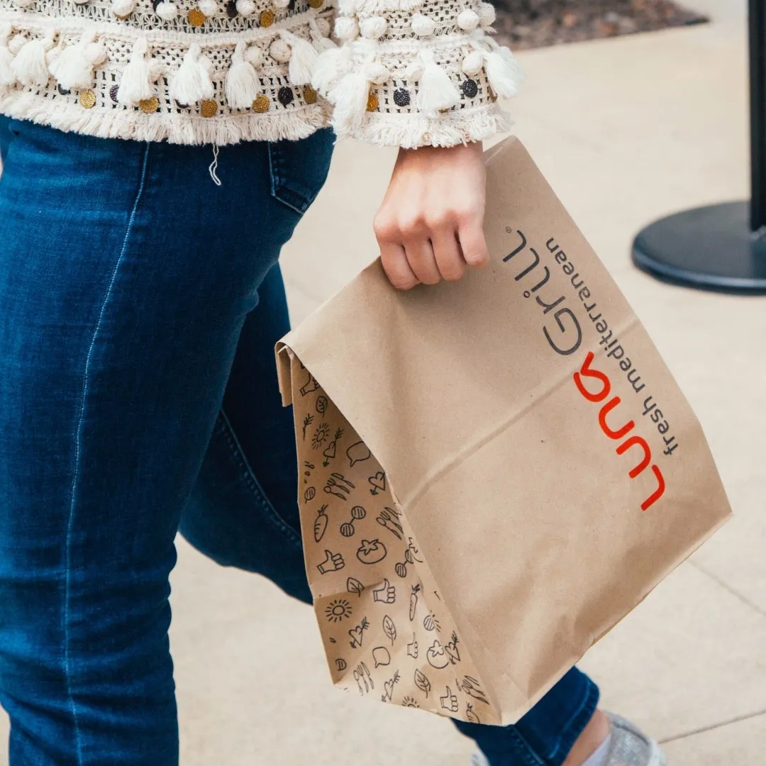 A kraft takeout bag printed in one color