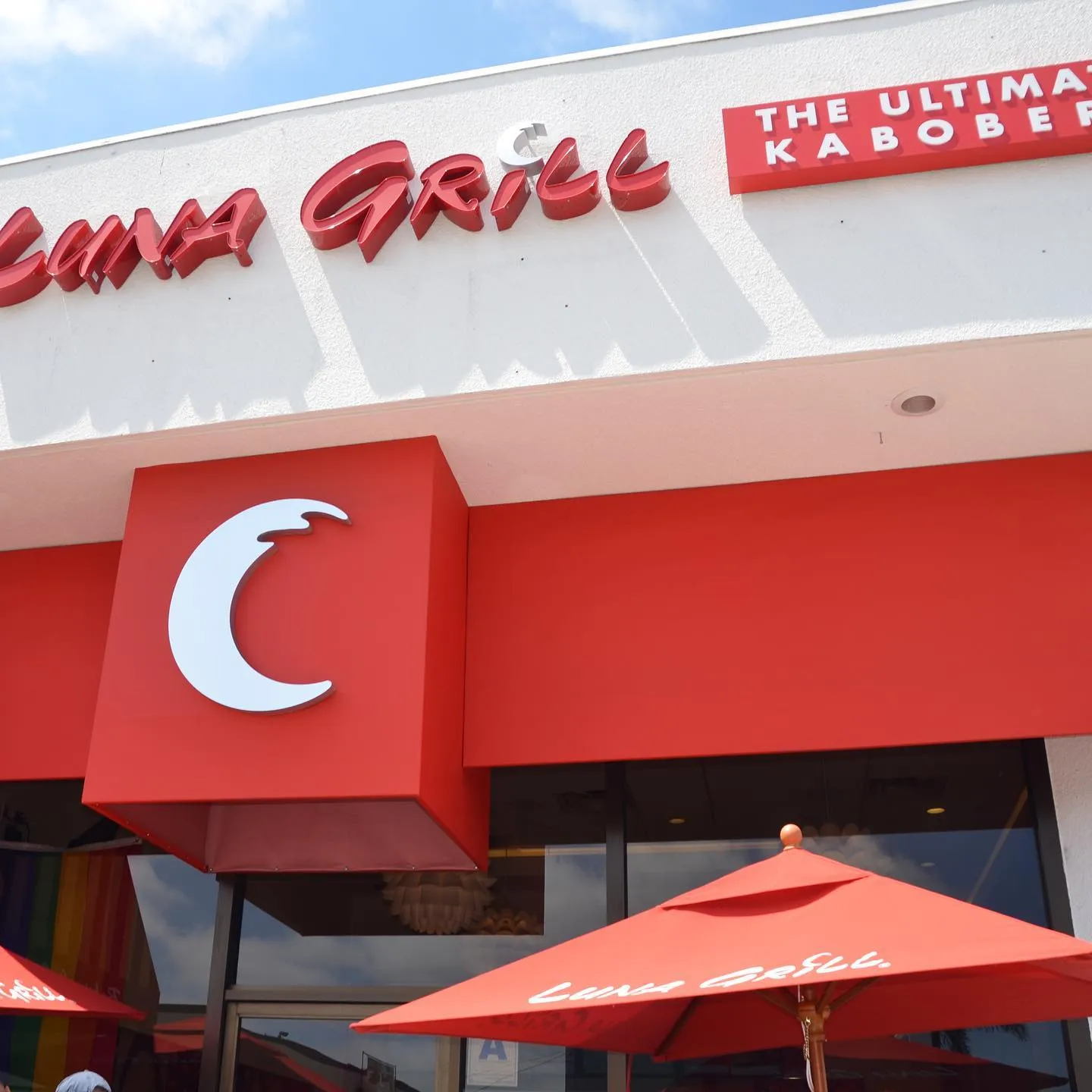 The original Luna Grill storefront with red brush script channel letters and a crescent moon blade sign