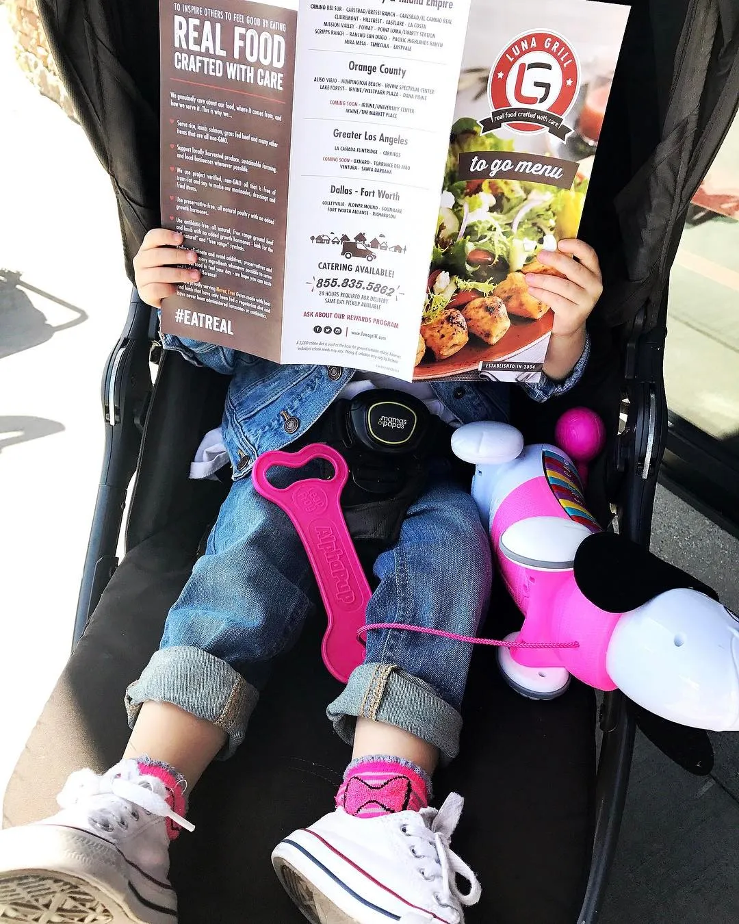 A child holding the printed to-go menu